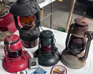 From left or right: W E P Co  #40 Traffic Gard w/ red globe, Construction/Traffic Deitz lantern with a 3" post mount & an amber globe, Milwaukee Gas Light lantern w/ ‘Dodge Co’ etched on the red globe, Little Wizard lantern w/ red globe. 1966 to 67 body by Fisher GM seatbelt latch, pheasants forever patch, and a Ducks Unlimited pen.