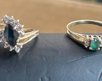 On the left - 14K gold ring w/ a saghire w/ diamonds, on the right is a 10K  gold ring w/ an  emerald and  diamonds.