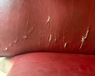 F23 - $30. Red Leather Chair. Measures 28" wide, 40" deep, 35" tall. Well worn, with cracking leather, but still useable.