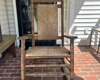 F73 - $85. Wooden Rocking Chair that was used on the covered porch. Measures 26.5" x 34" x 46" tall.