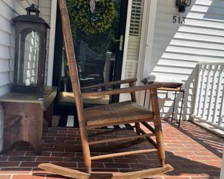 F73 - $85. Wooden Rocking Chair that was used on the covered porch. Measures 26.5" x 34" x 46" tall.
