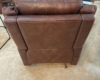 F12 - $400. Ashley Furniture Power Recliner with remote. Brown. Adjustable Lumbar and Headrest. Measures 36" wide x 37" deep x 42.5" tall.