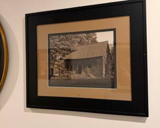 F63 - $20. Framed Photo of an Old Cabin. Measures 25" x 21" .