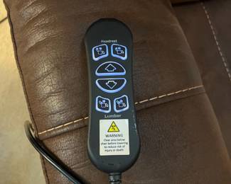 F12 - $400. Ashley Furniture Power Recliner with remote. Brown. Adjustable Lumbar and Headrest. Measures 36" wide x 37" deep x 42.5" tall.