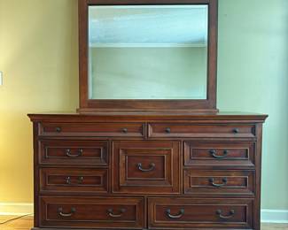 F35 - $275. Aspen Home Dresser with Mirror. Measures 66" wide, 20" deep, 80.5" with mirror. All drawers slide and it's in very good condition.