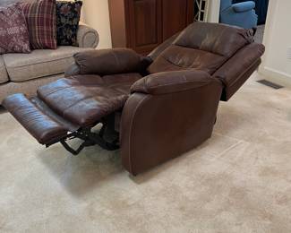 F12 - $400. Ashley Furniture Power Recliner with remote. Brown. Adjustable Lumbar and Headrest. Measures 36" wide x 37" deep x 42.5" tall.