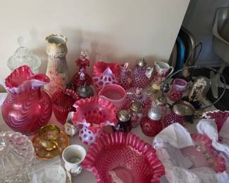 Large collection of cranberry glass. Some Fenton