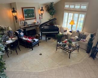 Baby grand piano | Couches | coffee table | leather chair | circular dining room table with glass top (includes another glass top)