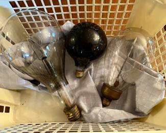 Gigantic antique light bulbs in a laundry basket