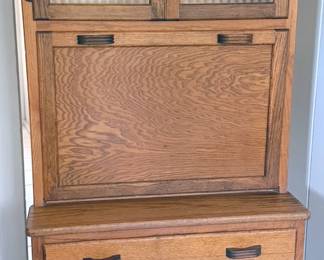 Hoosier cabinet with ribbed glass doors and fold-down worktop