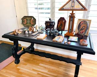 Wooden desk with leather top; religious iconography; Mission-style stained glass table lamp