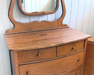 Bow-front tiger oak dresser with mirror