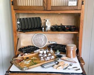 Hoosier cabinet with ribbed glass doors and fold-down worktop