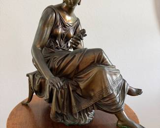 Bronze seated lady with rose