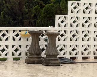 Vintage concrete umbrella stands with red umbrellas