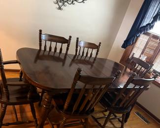 Dining table. Dark wood. Has leaf and six chiars. Many scratches on top of table.