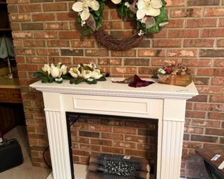 Free standing fireplace and electric logs.