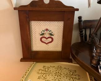 Vintage TV tray; cross stiched piece.