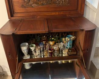 Mid-20th-century Chinese hand-carved teak flip-top dry bar cabinet (frequently brought back from East Asia by military personnel.)