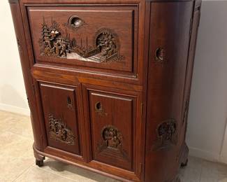 Mid-20th-century Chinese hand-carved teak flip-top dry bar cabinet (frequently brought back from East Asia by military personnel.)