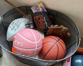 Signed football, basketballs, and baseball gloves