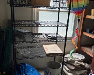 Black metal shelving, wire baskets, tarp, weeding bucket and more