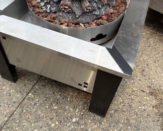 Another view of the Napolean stainless steel fire pit with ceramic logs