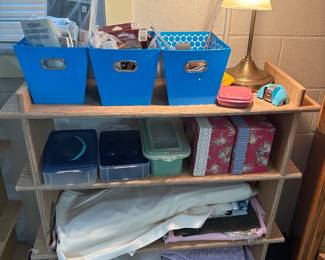 Sewing notions, bookcase, and table lamp