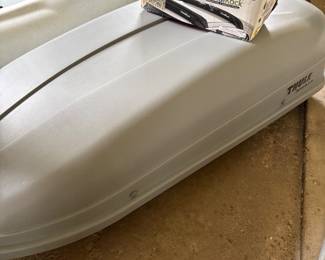 Thule rooftop cargo box and shown with Malone HandiRack carrier also