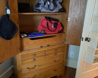 Wardrobe chest with storage drawers and shown with purses and some accessories