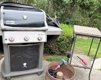 Weber Spirit LP grill, copper hose reel and granite/metal grilling side table