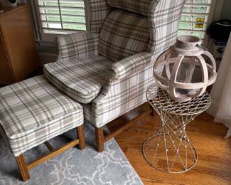 Armchair and ottoman shown with wire side table and wood candle-lantern