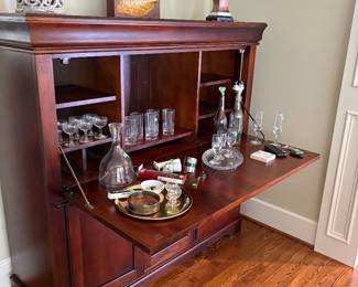 Storage console displayed as a bar station and shown with a lamp and decor