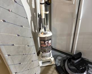 Shark vacuum sweeper, Roomba, and ironing board