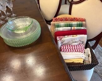 Glass chargers with green beading and depression glass bowl, tablecloths, runners, and napkins