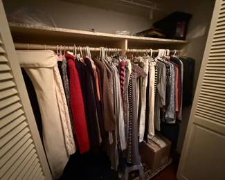 Master bedroom closet FULL of women’s clothes (this closet has upscale shirts, cardigans and pants/bottoms)