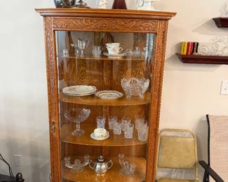 Oak china cabinet with several types of vintage glass and porcelain items, Several pieces of UV reactive glass