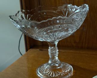 vintage pedestal compote bowl features a vibrant green glow under UV light