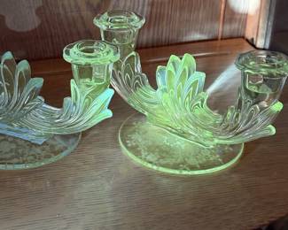 pair of vintage Fostoria Baroque candelabra features a distinctive two-light design and a vibrant yellow-green glow under UV light