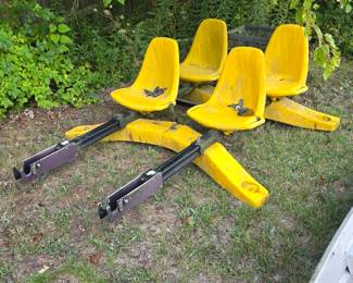 Four yellow bucket seats on frame
