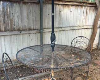 One of three patio tables with umbrellas