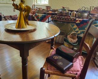 Pub table, pair antique chairs. Copper and rugs in background.