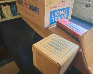 Preparing to unpack vintage Lionel cars in original boxes