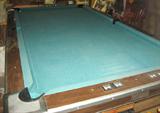 Good table cover on Brunswick pool table, notice counters at near front side, pool balls too