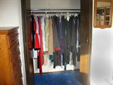 Six closets of women's clothing hanging on hangers