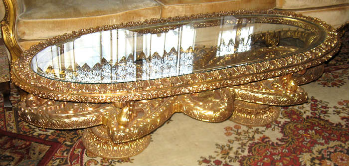 Ornate hors d'eurves table, heavy glass top, base made of composition material