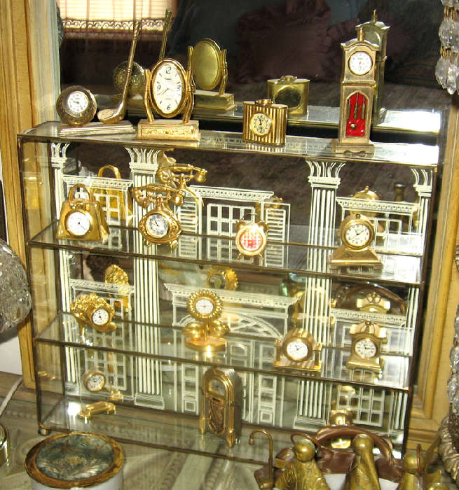 Miniature clock collection in display cabinet