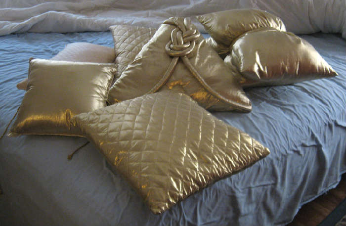 Gold silky accent pillows