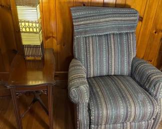 Stylish Recliner With Multicolor Striped Pattern With Wooden Side table And Tall Rattan Lamp