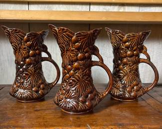 151 trioofbrownembossedceramicpitchers